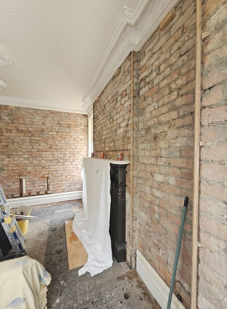 Period room with the walls stripped back to bare brick