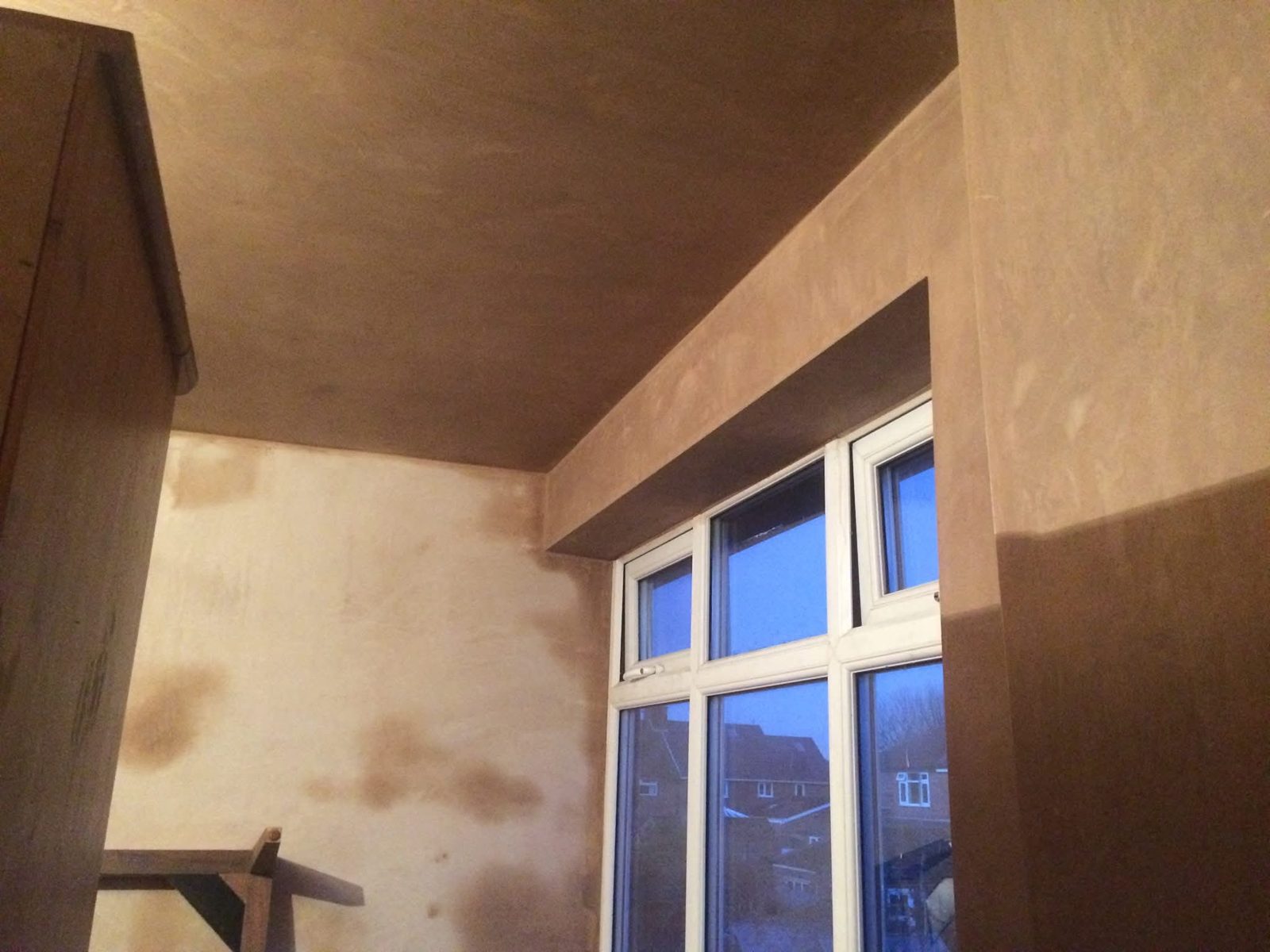 Freshly skimmed room with a bay window, the plaster still drying